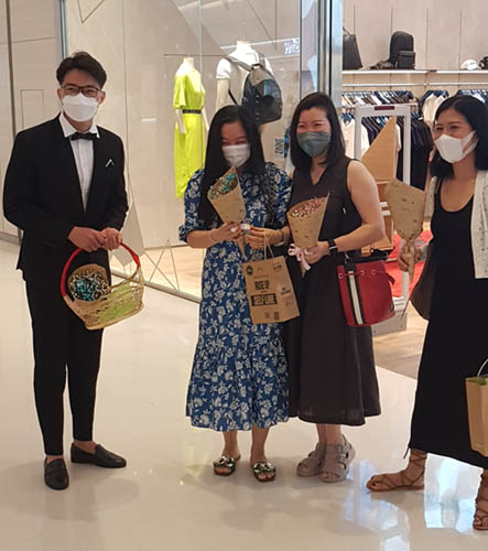 Shopping mall staff giving flowers to female customers at Crescent Mall, District 7, Ho Chi Minh City